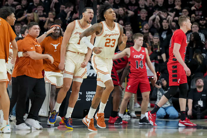 Texas Longhorns forward Dylan Disu (1) and forward Dillon Mitchell (23) celebrate defeating the Cincinnati Bearcats at Fifth Third Arena.